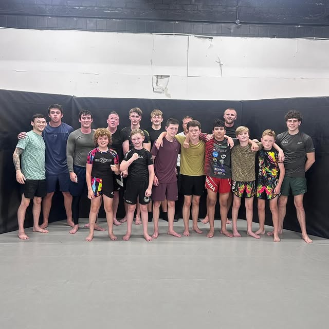 The beginners jiu jitsu group lined up together at the end of a session.